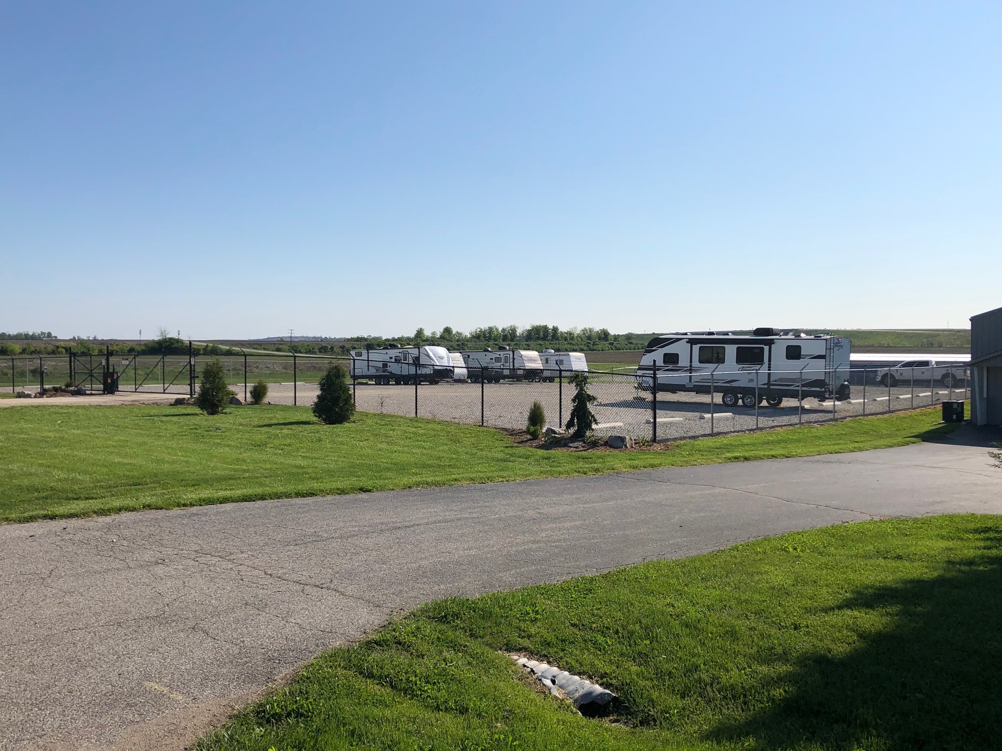Secured and fenced area for boat and RV parking at Washington, IN Access Storage, providing safe and spacious storage options.